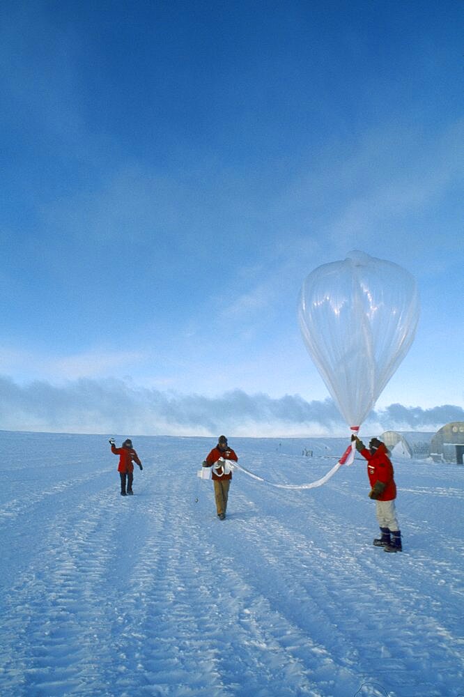 ANTARCTICA  South Pole Three figures launching a balloon to measure amounts of ozone in the air at various altitudes.   US Amundsen-Scott South Pole Station.