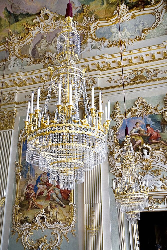 Germany, Bavaria, Munich, Nymphenburg Palace. Interior of Steinerner Saal the Stone or Great Hall with detail of paintings elaborate chandelier and gold and white baroque decoration by Francois de Cuvillies.