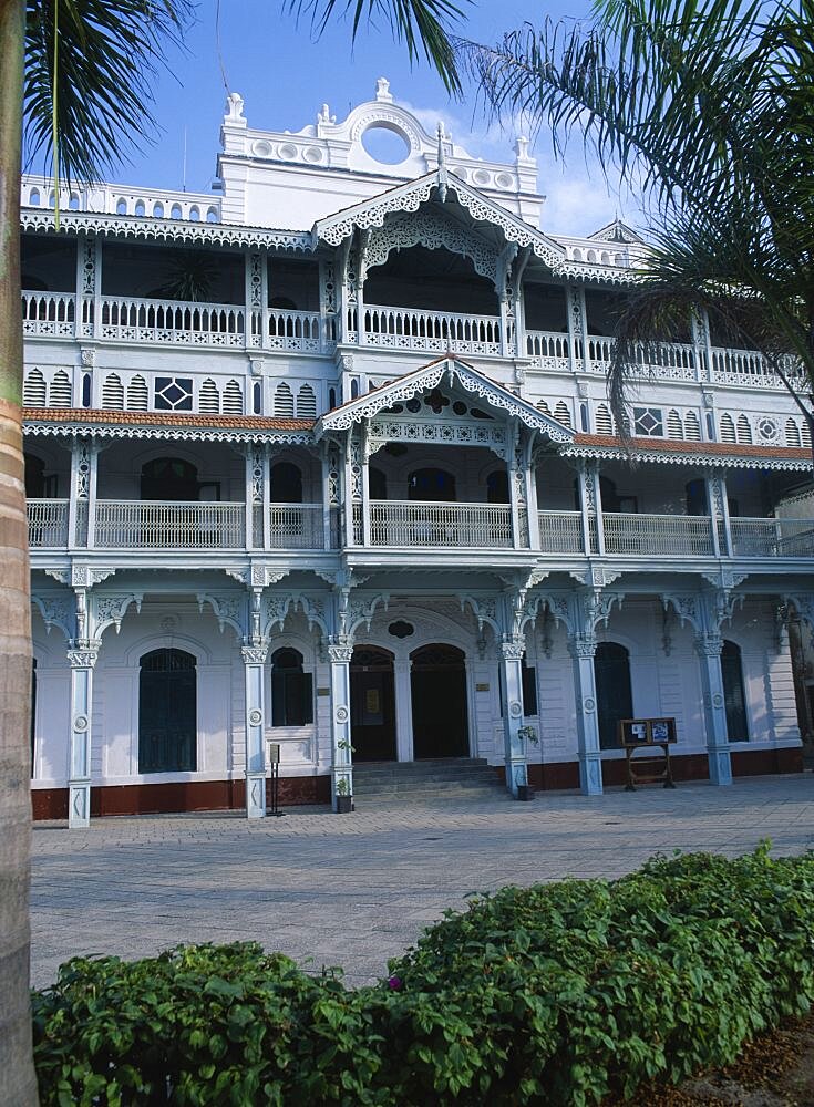 TANZANIA Zanzibar Island Zanzibar Stone Town. The Old Dispensary  four storey building with decorative balconies  built in the 1890s.  Exterior view with palms in the foreground.