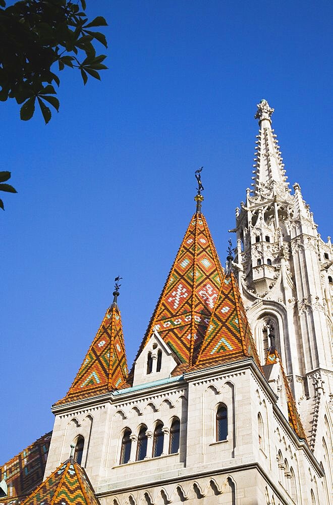 Hungary, Budapest, Buda Castle District, the tiled Bela tower with Matyas Church behind.