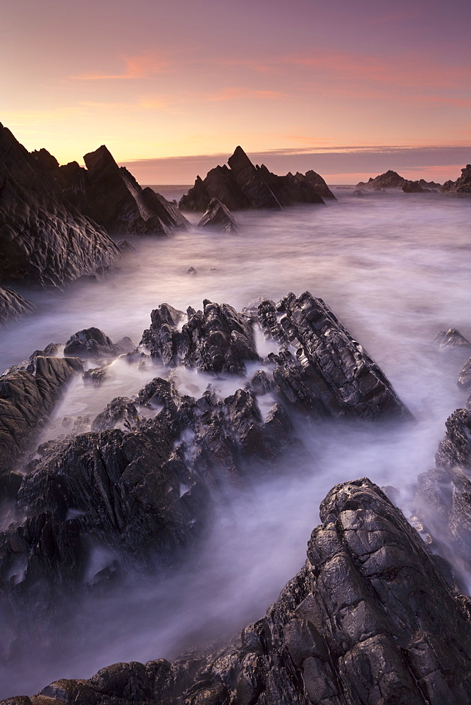 Broken rock ledges at Hartland Quay at sunset, North Devon, England, United Kingdom, Europe