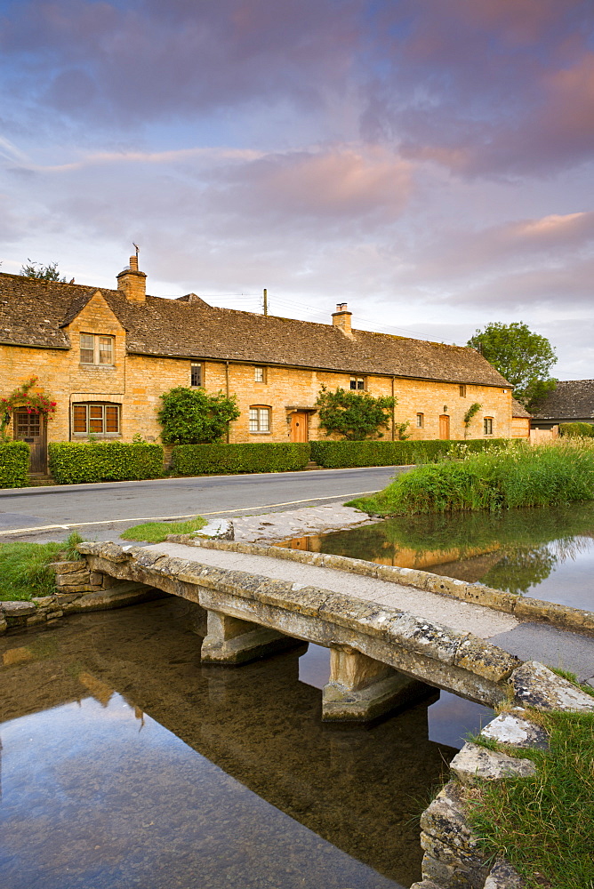 Footbridge and cottages in the picturesque Cotswold village of Lower Slaughter, Gloucestershire, The Cotswolds, England, United Kingdom, Europe