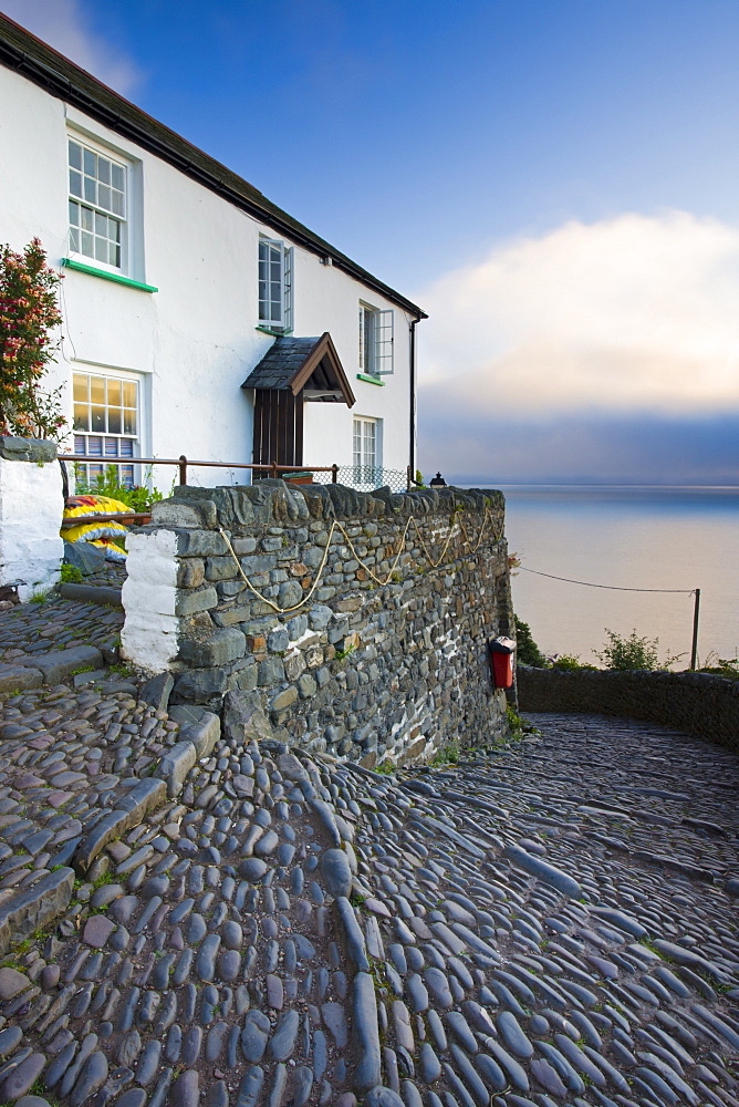 Winding cobbled lane and whitewashed cottage in Clovelly, Devon, England, United Kingdom, Europe