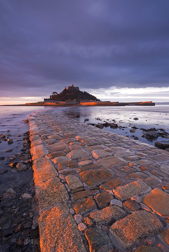 First light of day in winter on the stone causeway leading to St. Michaels Mount, Marazion, Cornwall, England, United Kingdom, Europe