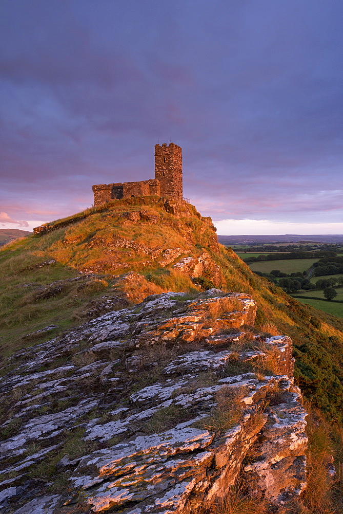 Rich evening sunlight illuminates Brentor Church in Dartmoor National Park, Devon, England, United Kingdom, Europe