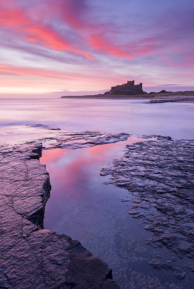 Sunrise over Bamburgh Castle on the Northumberland coast, Northumberland, England, United Kingdom, Europe