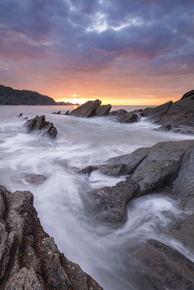 Colourful sunset sky above rocky Combe Martin on the north Devon coast, Exmoor National Park, Devon, England, United Kingdom, Europe