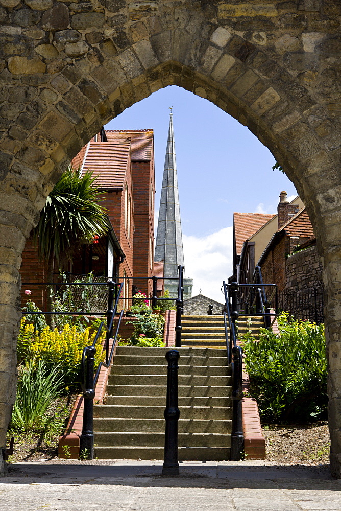 St. Michael's Church and modern housing developments seen through a medieval wall arch in walls, Southampton, Hampshire, England, United Kingdom, Europe