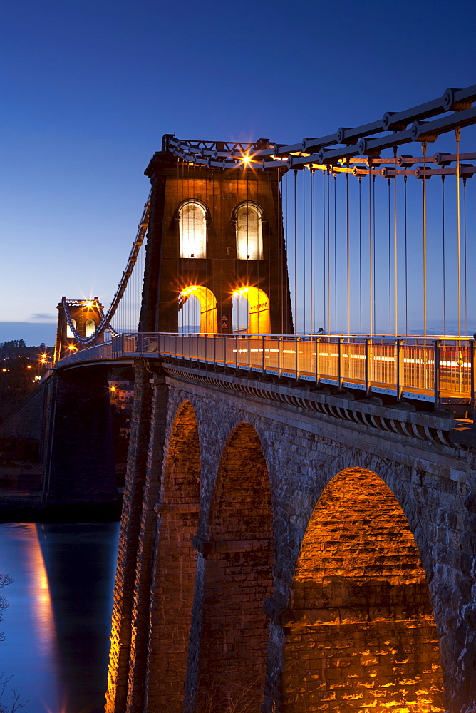 Evening illuminations on the Menai Bridge spanning the Menai Strait, North Wales, Wales, United Kingdom, Europe