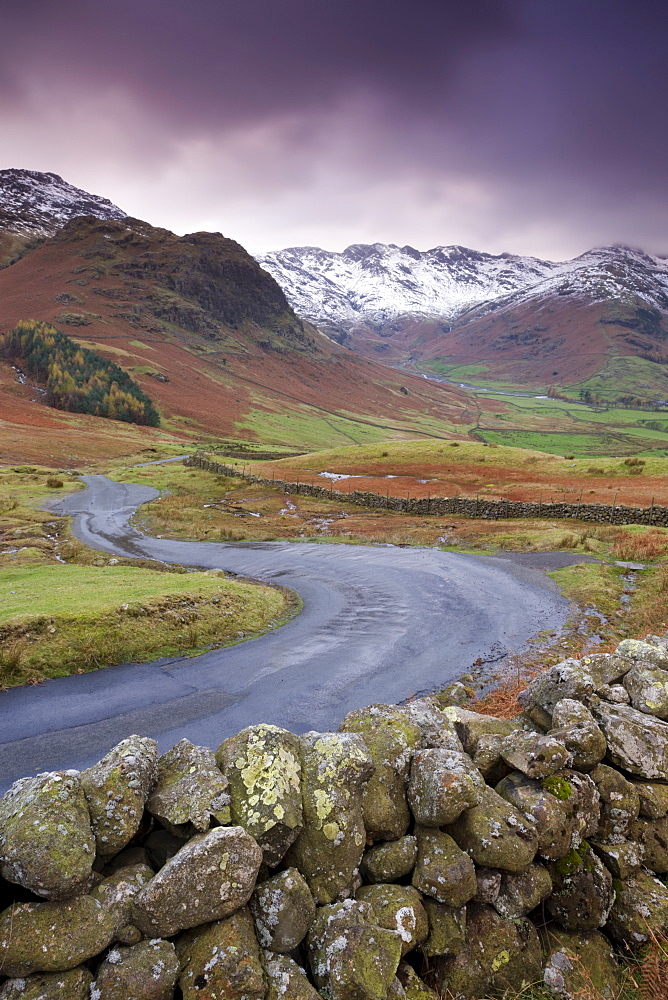 A winding mountain road descends into Great Langdale valley, Lake District National Park, Cumbria, England, United Kingdom, Europe