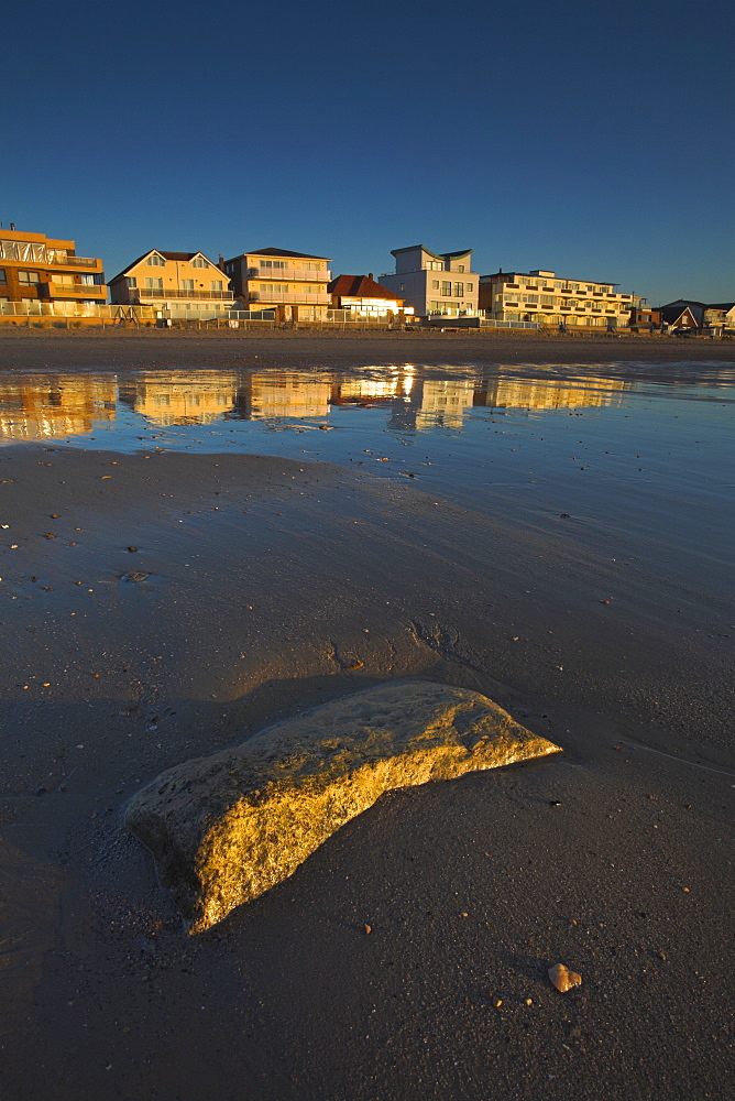 Multi-million pound houses glow in the morning sunshine at Sandbanks, Dorset, England, United Kingdom, Europe