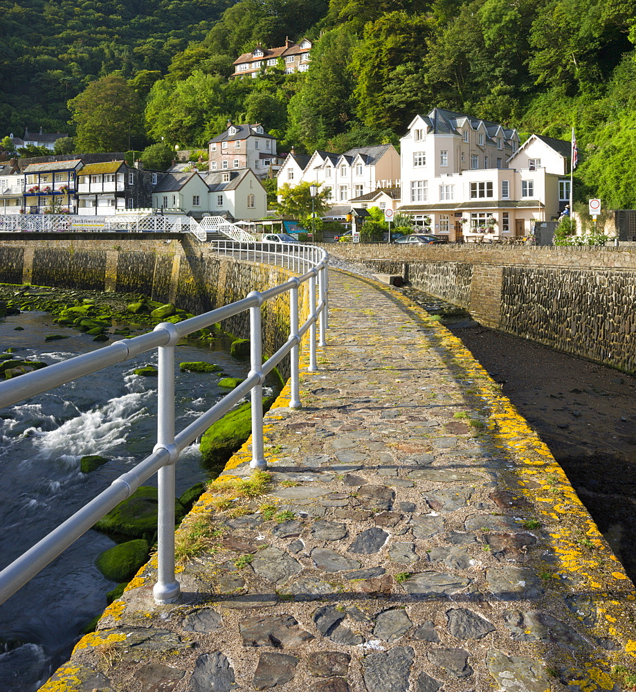 Stone harbour wall and village of Lynmouth on a summer morning, Exmoor National Park, Devon, England, United Kingdom, Europe