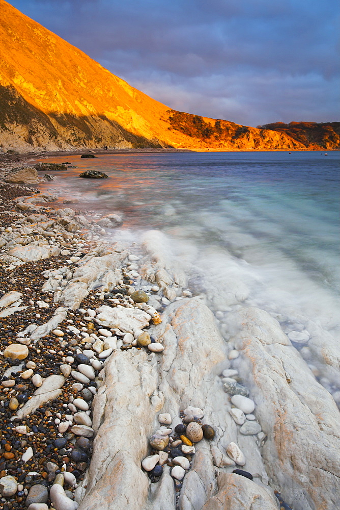 Sunlight glows on the cliffs at Lulworth Cove, Jurassic Coast, UNESCO World Heritage Site, Dorset, England, United Kingdom, Europe