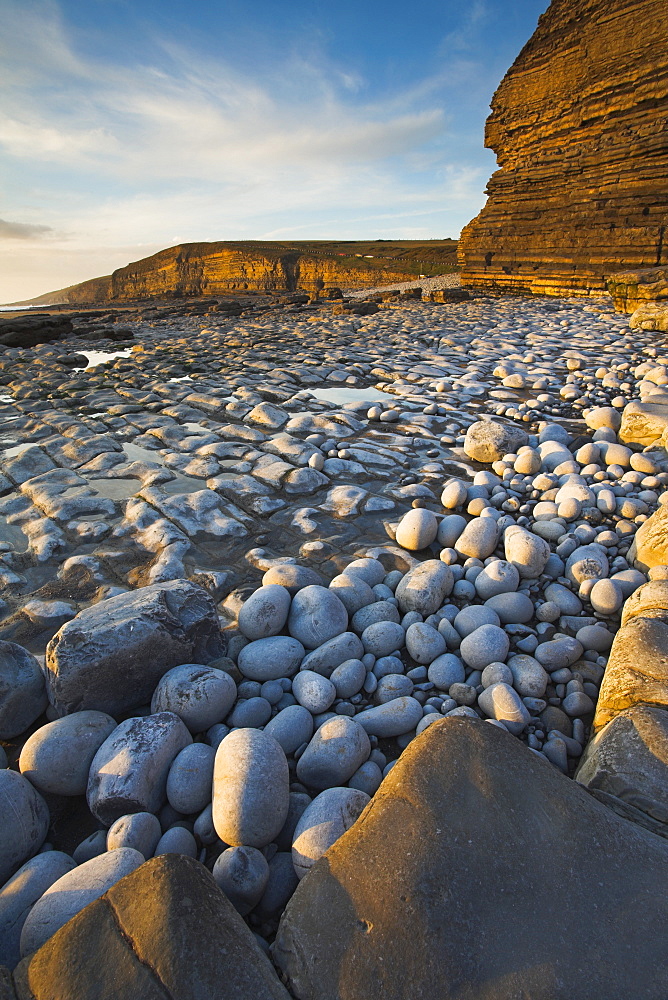 Golden evening sunshine lights up the rocks, Dunraven Bay, Southerndown, Wales, United Kingdom, Europe