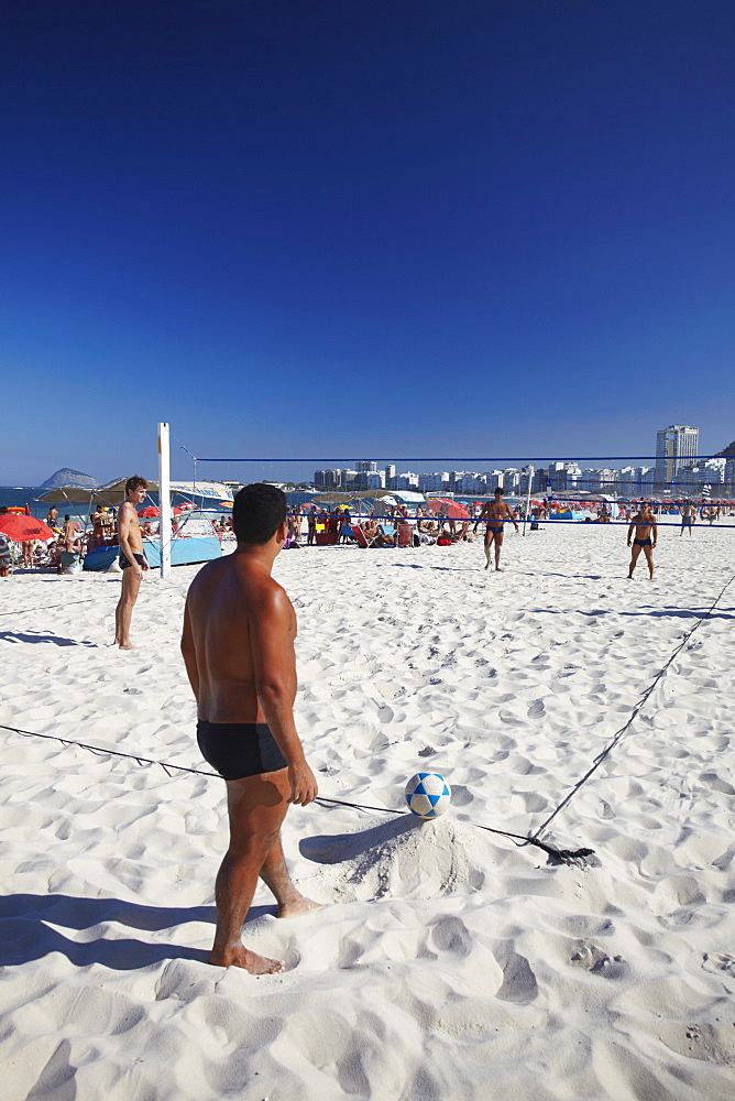 Men playing foot volley (futevolei) on Copacabana beach, Rio de Janeiro, Brazil, South America 