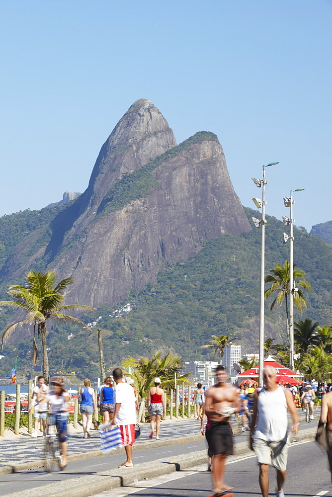 People cycling and walking along pedestrianised street on Sunday, Ipanema, Rio de Janeiro, Brazil, South America 