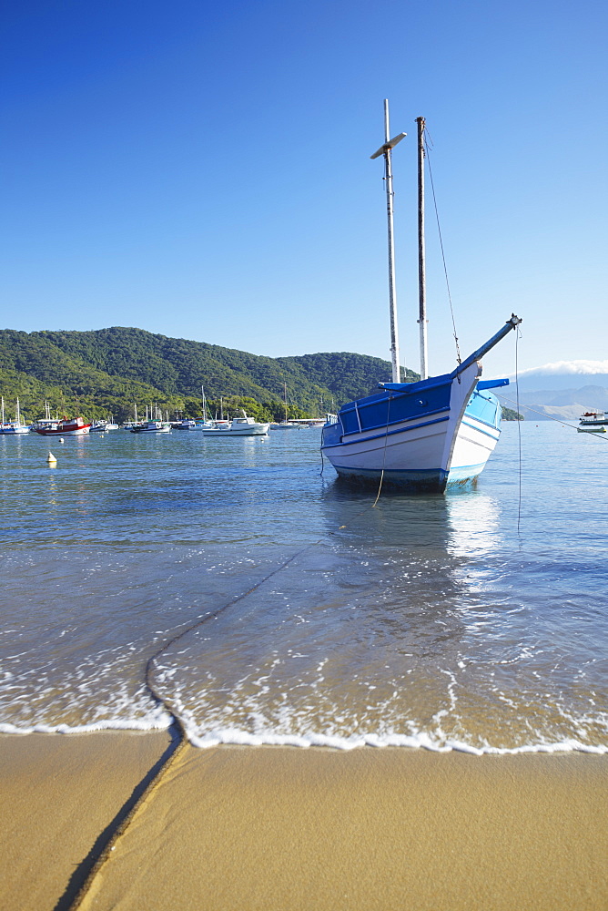 Boats moored on Vila do Abraao beach, Ilha Grande, Rio de Janeiro State, Brazil, South America 