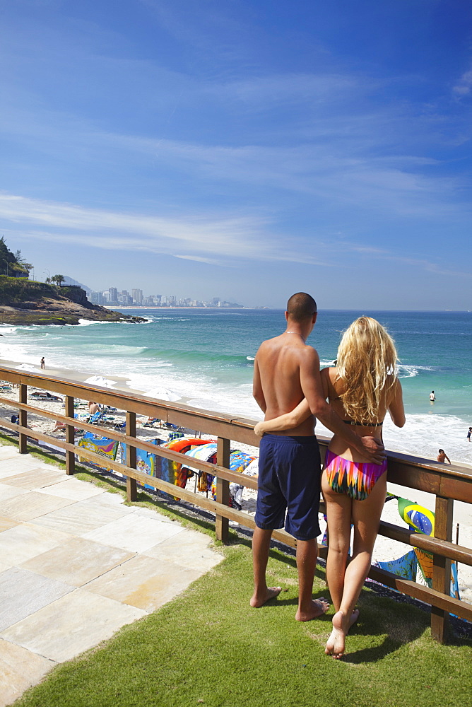 Couple standing in grounds of Sheraton Hotel overlooking beach, Rio de Janeiro, Brazil, South America 