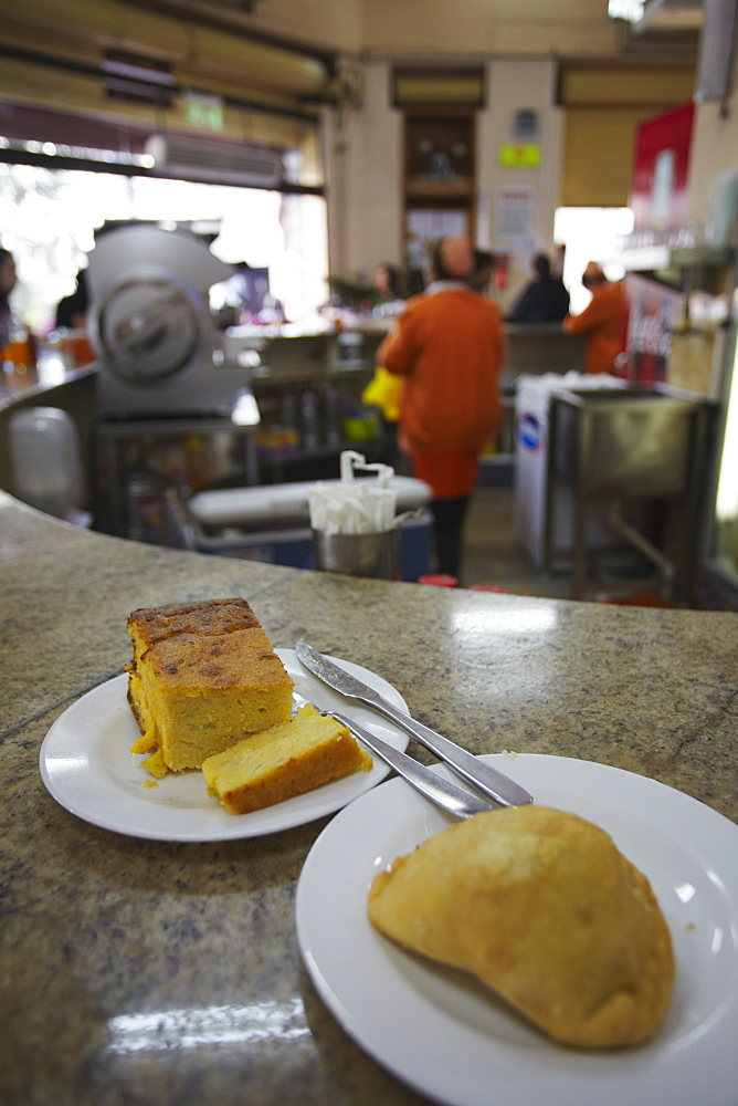 Sopa paraguaya (cornbread with cheese and onion) and empanada in Lido Bar, Asuncion, Paraguay, South America