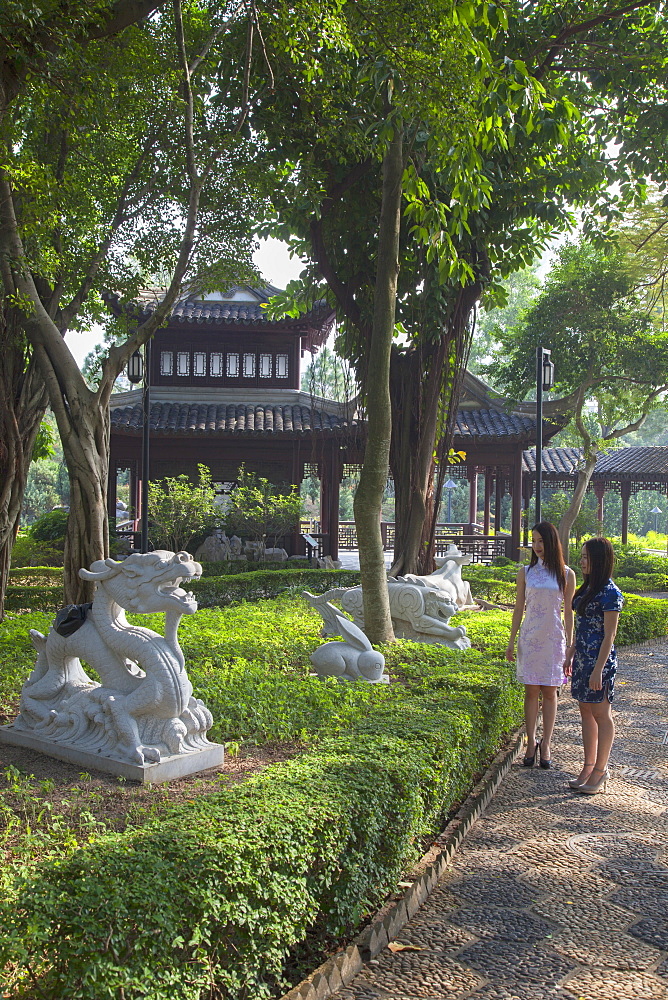 Women wearing traditional cheongsam dress in Kowloon Walled City, Kowloon, Hong Kong, China, Asia 