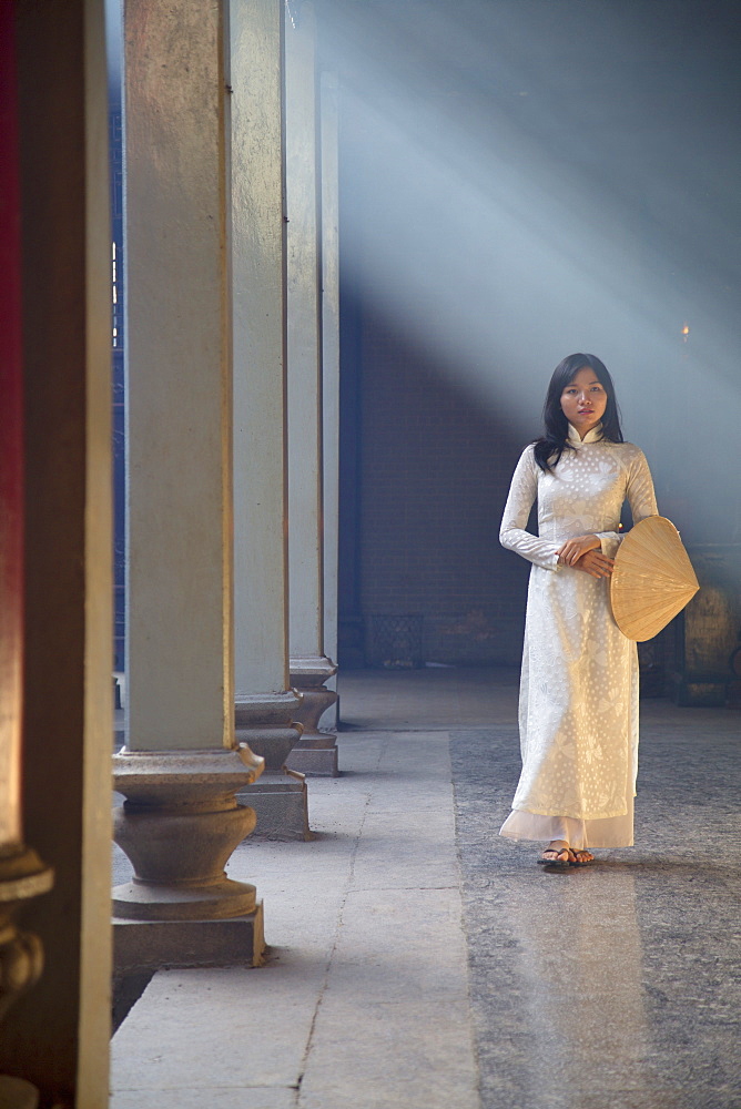 Woman wearing ao dai dress at Thien Hau Pagoda, Cholon, Ho Chi Minh City, Vietnam, Indochina, Southeast Asia, Asia