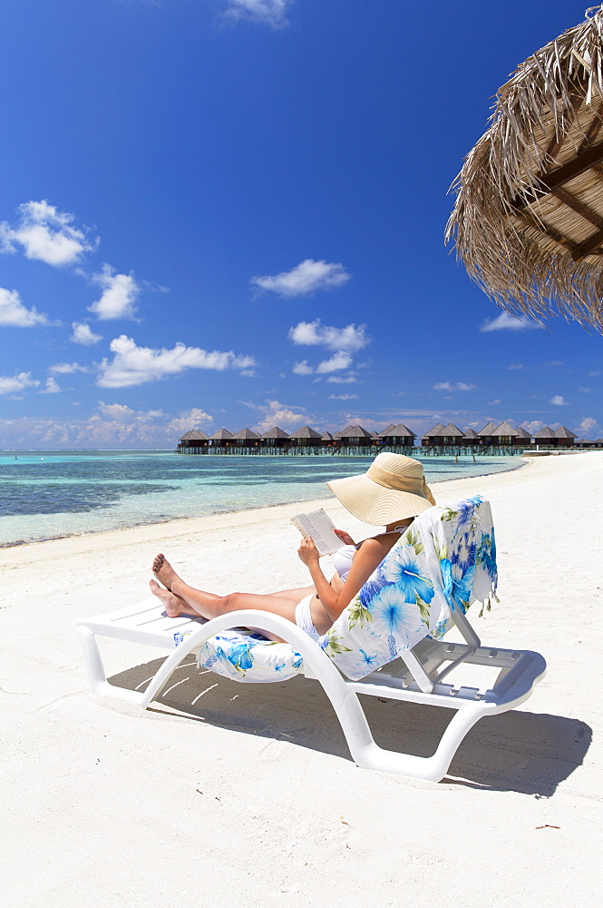 Woman on beach at Olhuveli Beach and Spa Resort, South Male Atoll, Kaafu Atoll, Maldives, Indian Ocean, Asia