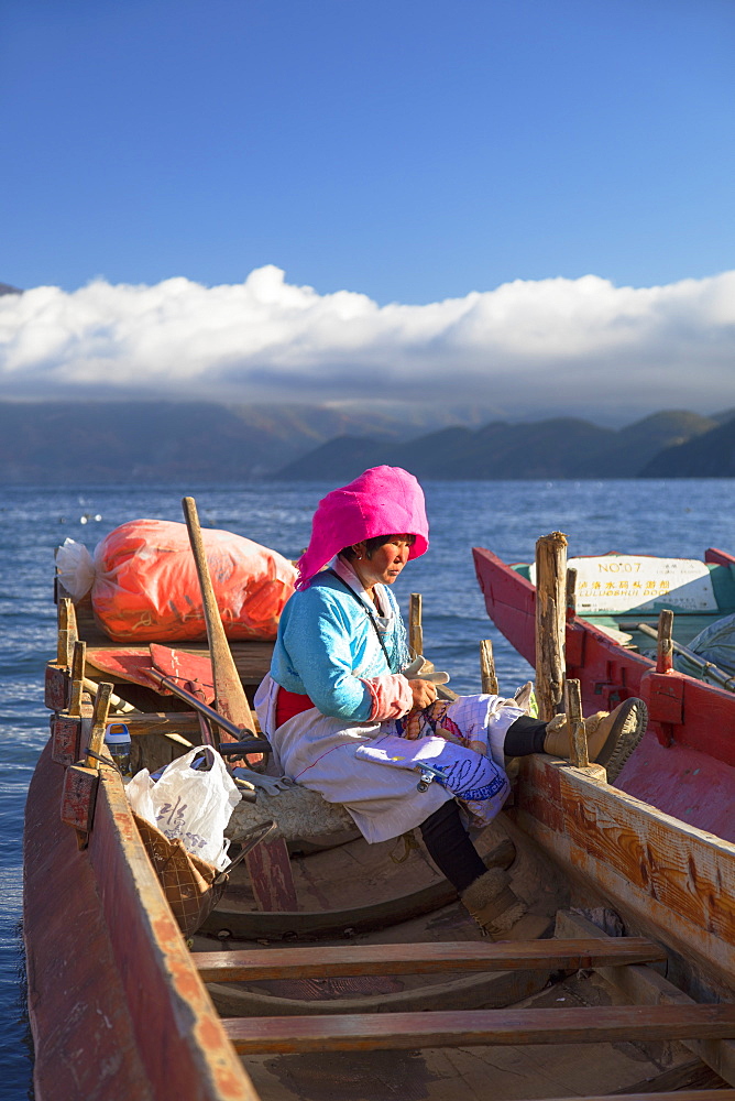 Mosu woman on boat, Luoshui, Lugu Lake, Yunnan, China, Asia