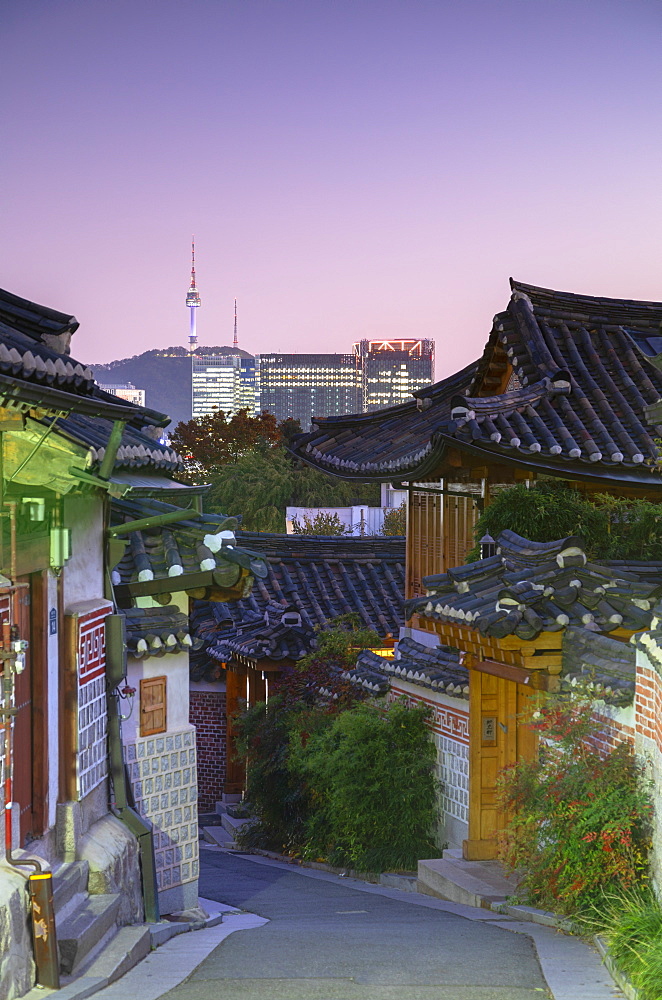 Traditional houses in Bukchon Hanok village and Namsan Seoul Tower at dusk, Seoul, South Korea, Asia