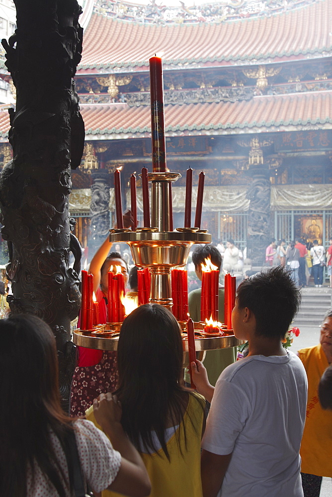 People lighting incense sticks, Longshan Temple, Taipei, Taiwan, Asia