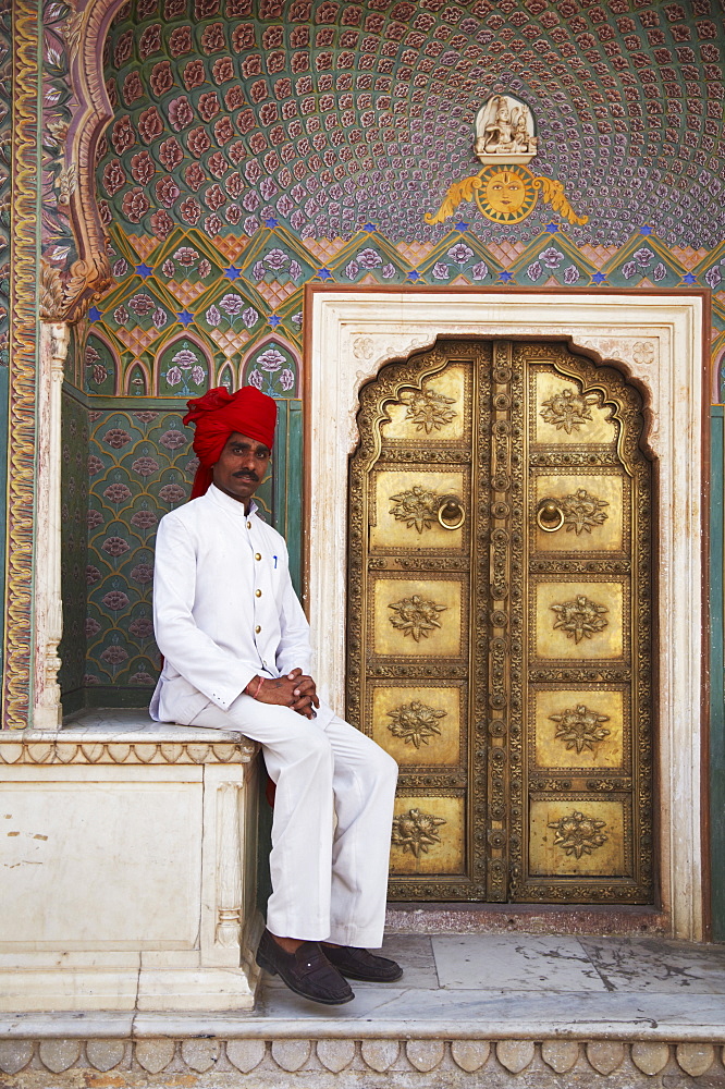 Palace guard sitting at Rose Gate in Pitam Niwas Chowk, City Palace, Jaipur, Rajasthan, India, Asia