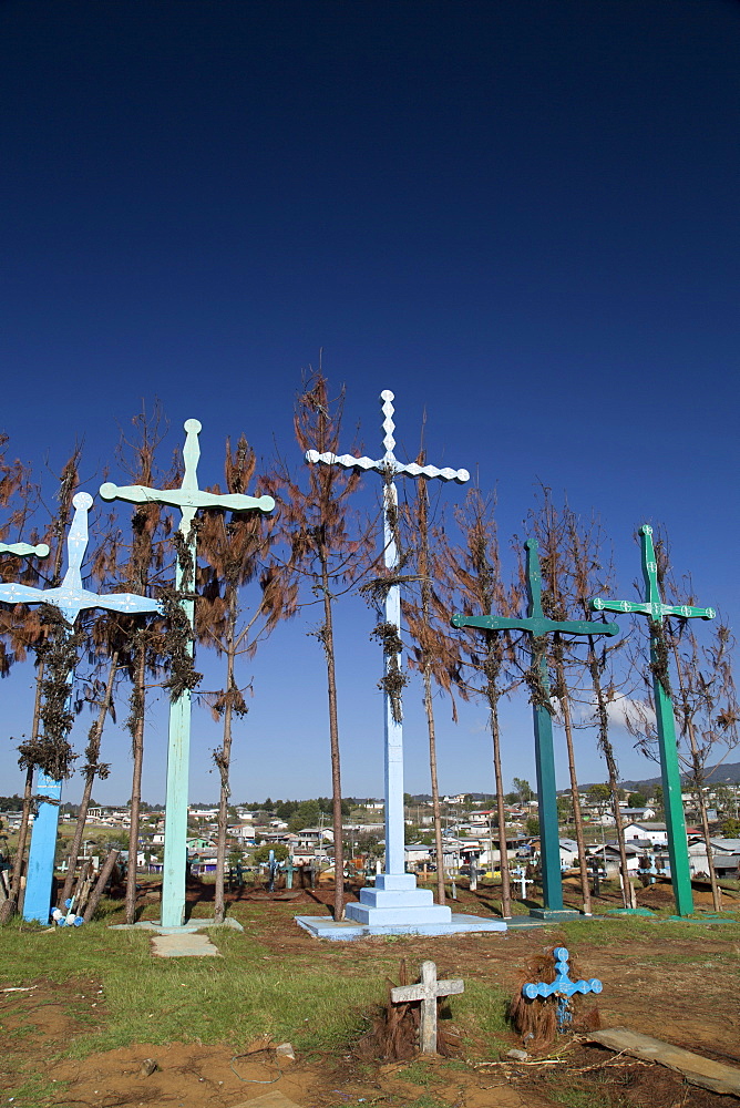 A series of tall crosses at the crest of the graveyard, boards represent doors to and from the grave, village of El Romerillo, Chiapas, Mexico, North America 