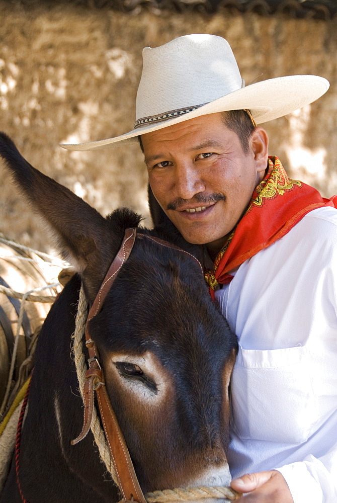 Local Mexican in traditional dress with donkey at the distillery of Herradura tequila, Hacienda San Jose del Refugio, Amatitan, Jalisco, Mexico, North America