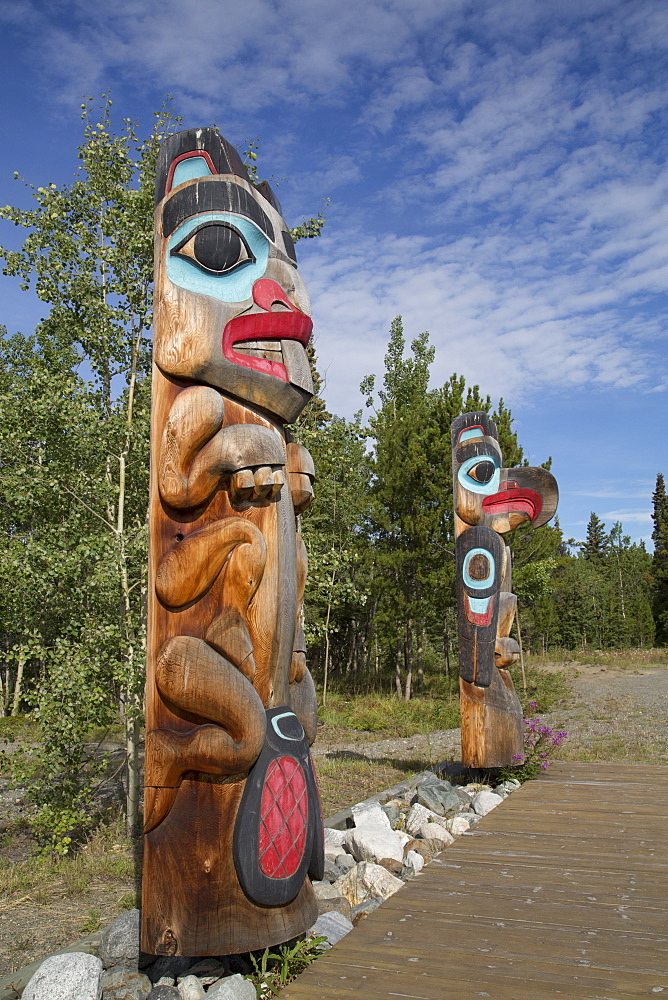 Totem poles with beaver image in the foreground, Teslin Tlingit Heritage Center, Teslin, Yukon, Canada, North America