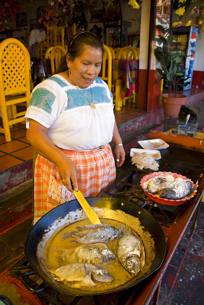 Local woman cooking fish, Isla Janitzio, Lago de la Patzcuaro, Patzcuaro, Michoacan, Mexico, North America