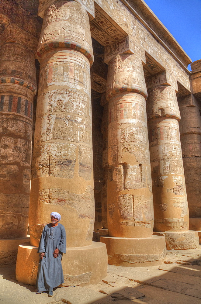 Local man, Columns in the Great Hypostyle Hall, Karnak Temple, Luxor, Thebes, UNESCO World Heritage Site, Egypt, North Africa, Africa