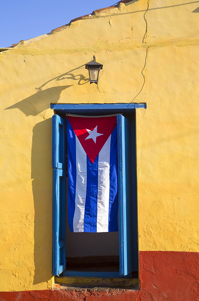 Cuban flag in doorway, Trinidad, UNESCO World Heritage Site, Sancti Spiritus, Cuba, West Indies, Central America