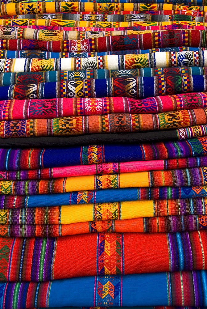 Textiles for sale in the market in the village of Pisac, The Sacred Valley, Peru, South America