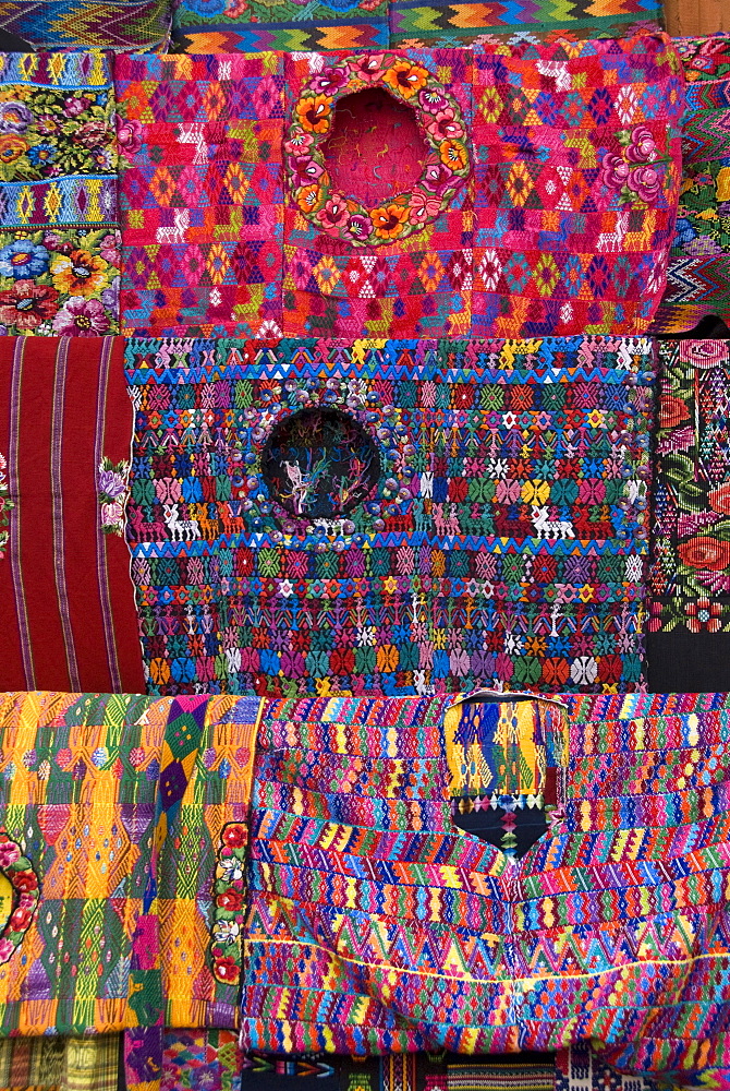 Traditional huipils (square cut blouses) for sale in the market, Chichicastenango, Guatemala, Central America