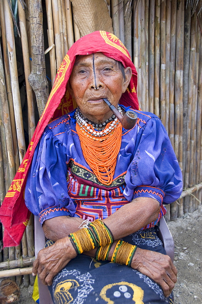 Kuna woman smoking a pipe, Playon Chico Village, San Blas Islands (Kuna Yala Islands), Panama, Central America