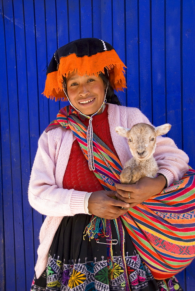 Inca woman in traditional dress with small lamb, Pisac, Sacred Valley, Peru, South America