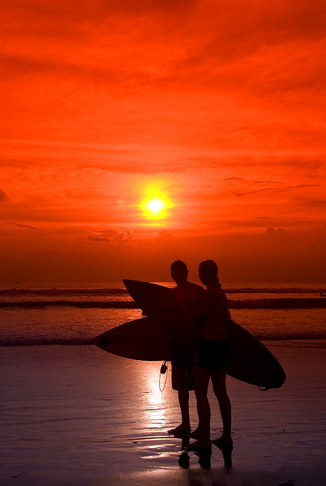 Two surfers calling it a day, Kuta Beach, Bali, Indonesia, Southeast Asia, Asia