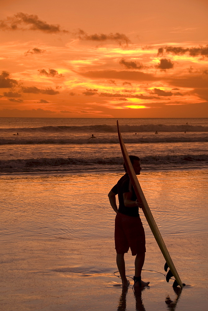 Surfer at sunset, Kuta Beach, Bali, Indonesia, Southeast Asia, Asia