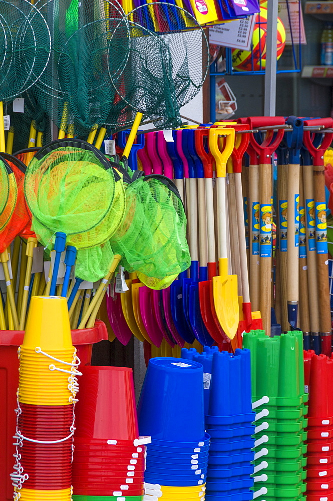 Traditional buckets and spades on sale in a seaside shop in Lyme Regis, Dorset, England, United Kingdom, Europe 