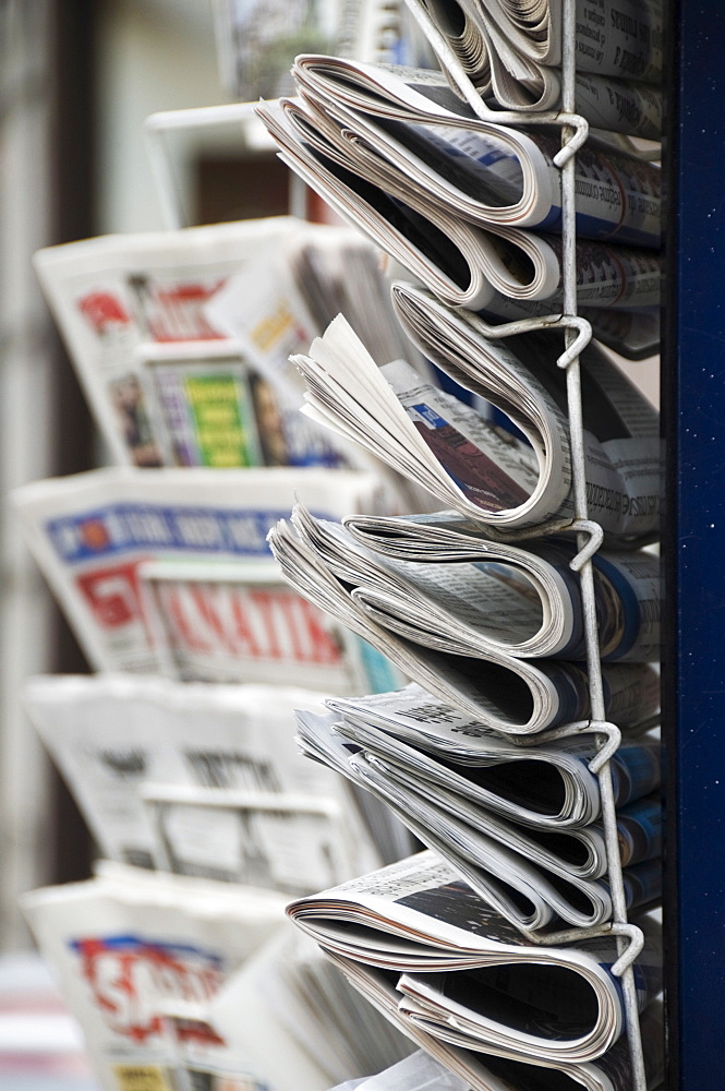 A collection of international newspapers on sale in Fleet Street, London, England, United Kingdom, Europe