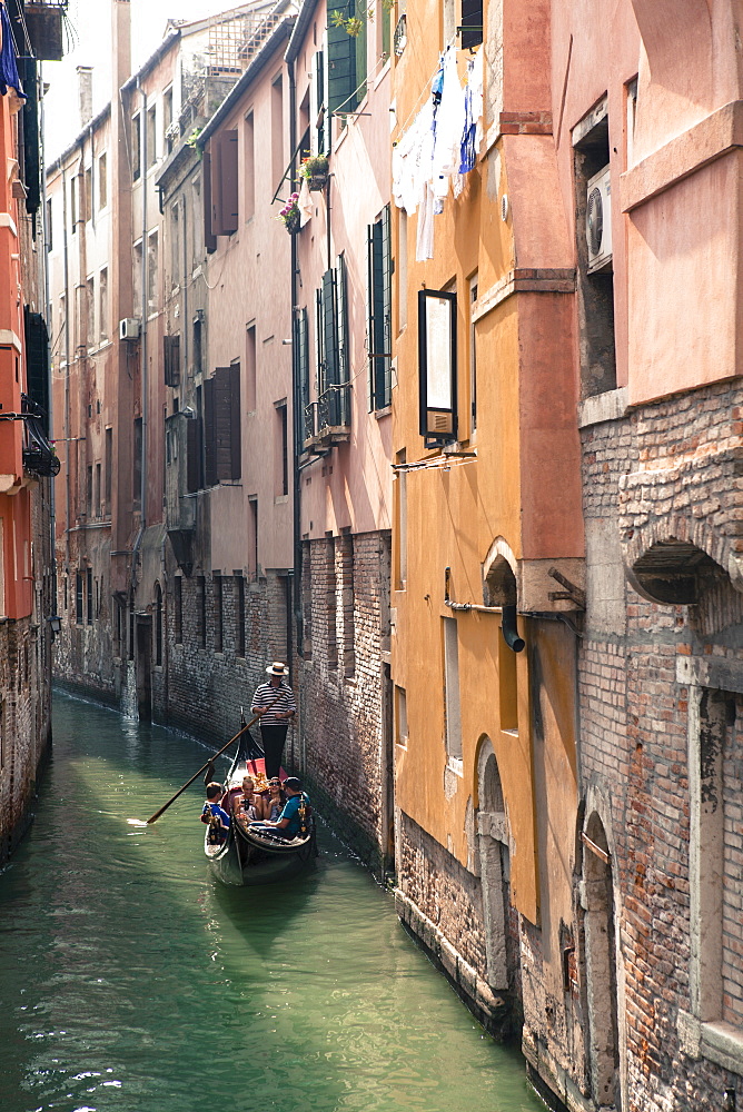 Gondola with tourists on a narrow canal, Venice, UNESCO World Heritage Site, Veneto, Italy, Europe