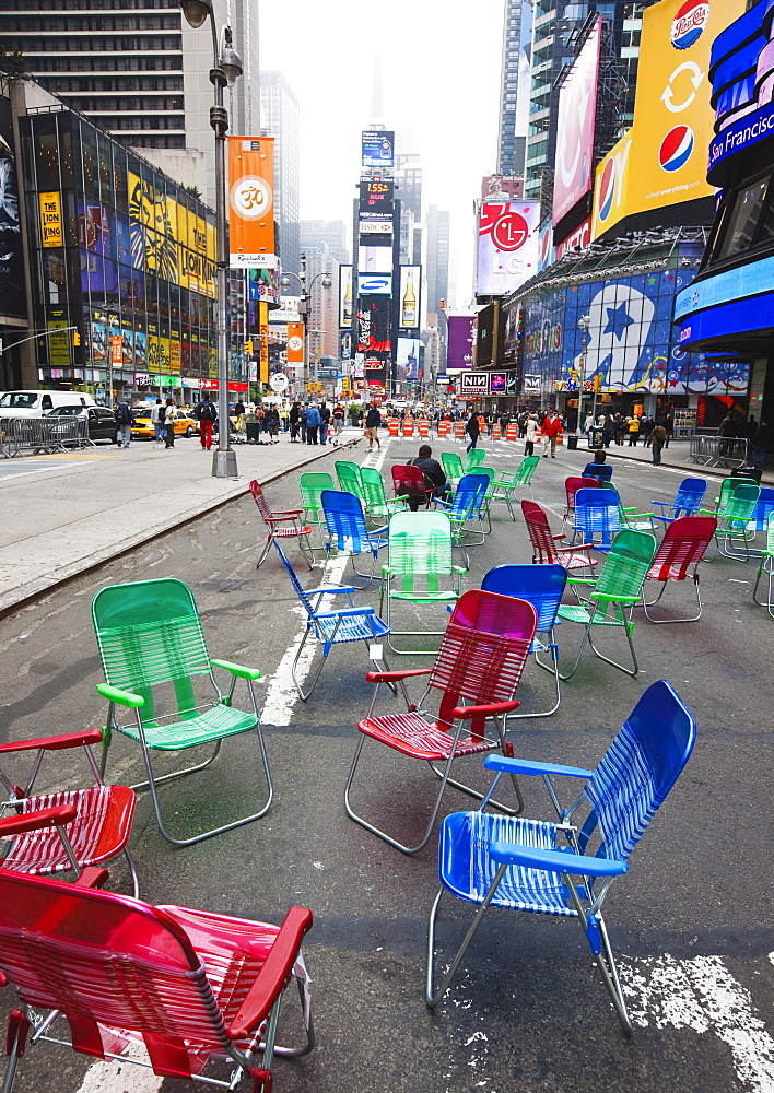 Garden chairs in the road for the public to sit and relax in the pedestrian zone, Times Square, New York City, New York, United States of America, North America