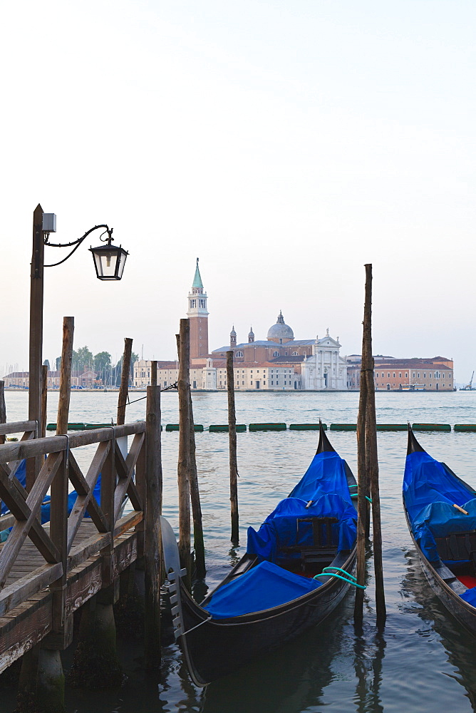 Gondolas moored on the Lagoon, San Giorgio Maggiore beyond, Riva degli Schiavoni, Venice, UNESCO World Heritage Site, Veneto, Italy, Europe