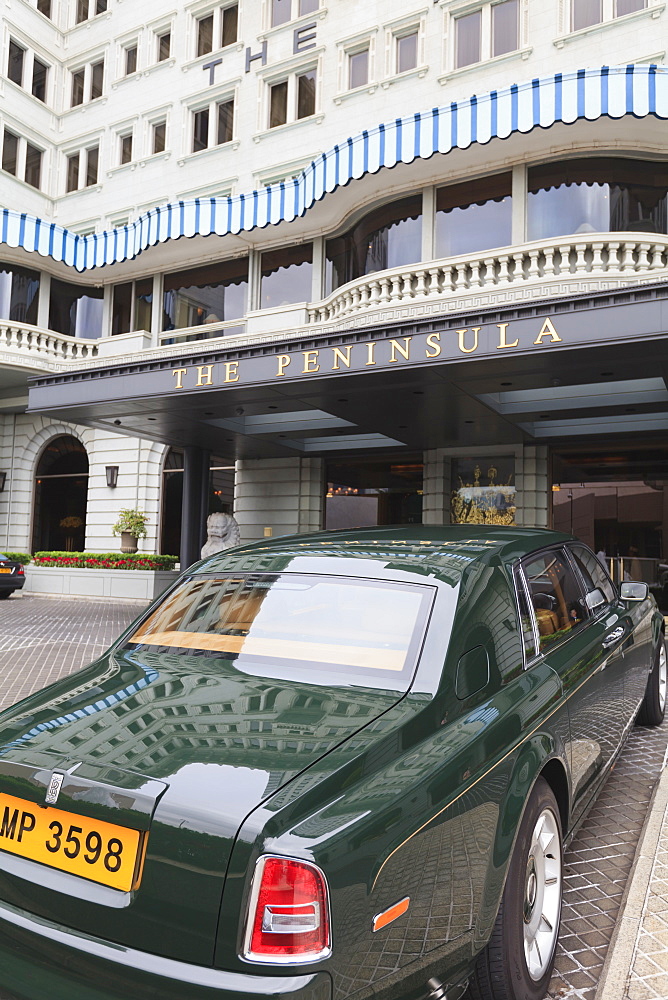 The Peninsula Hotel and one of the hotel's fleet of green Rolls Royces, Hong Kong, China, Asia