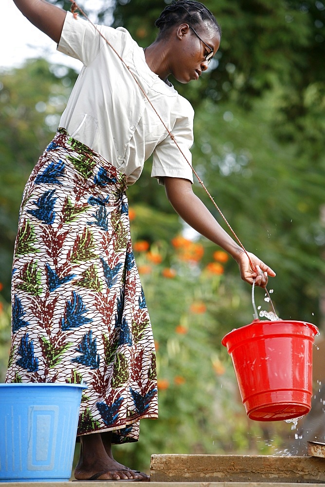 Woman getting water from a cistern, Popenguine, Thies, Senegal, West Africa, Africa