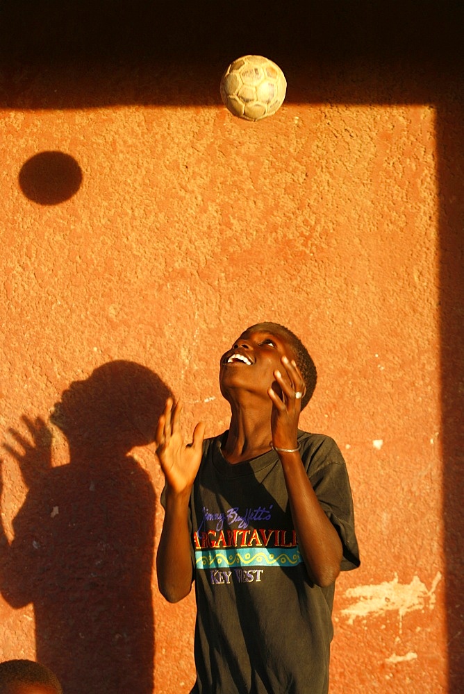 Guinean child playing with a ball, Douggar, Thies, Senegal, West Africa, Africa